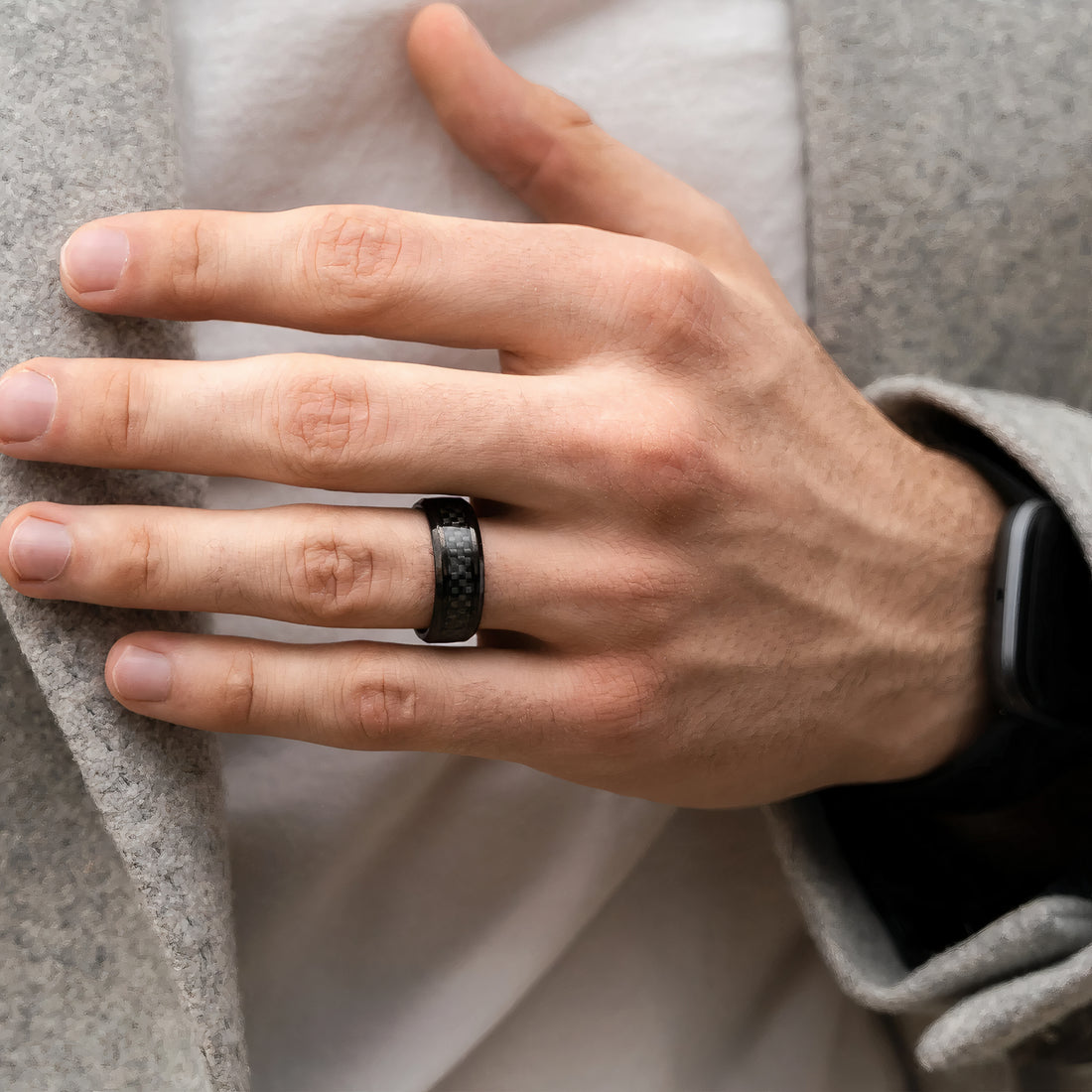 An 8mm wide carbon fiber tungsten ring, featuring a smooth, polished finish and a contemporary style, perfect for everyday wear.