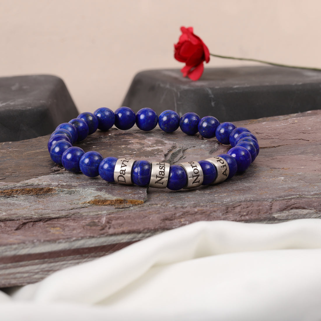 Custom lapis lazuli bracelet featuring family name engravings, perfect for a husband or father