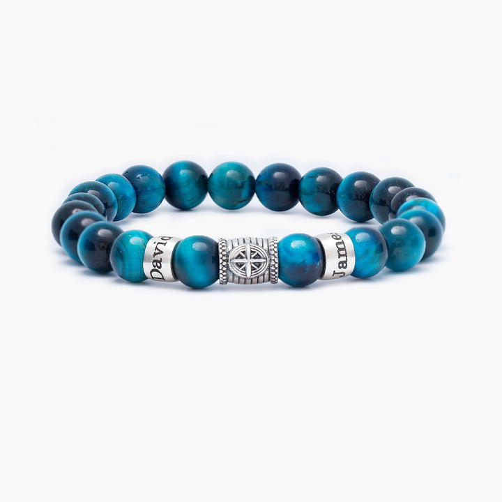 Custom blue tiger eye bracelet with engraved names and compass charm for son or father, showcasing natural stone shimmer and personalized detail.