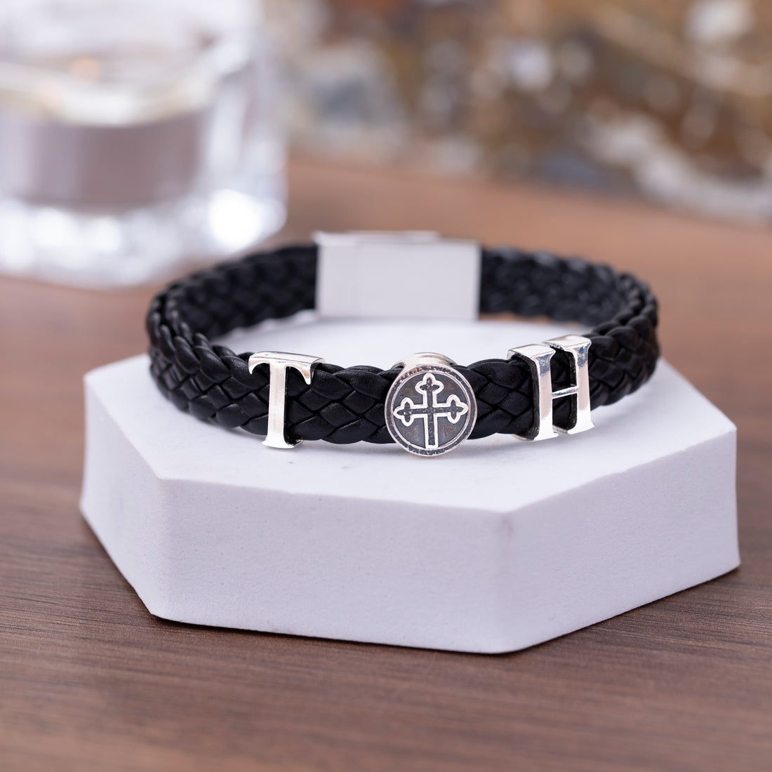 A hand model displaying the custom initial bracelet, emphasizing the unique personalization for a special male recipient.