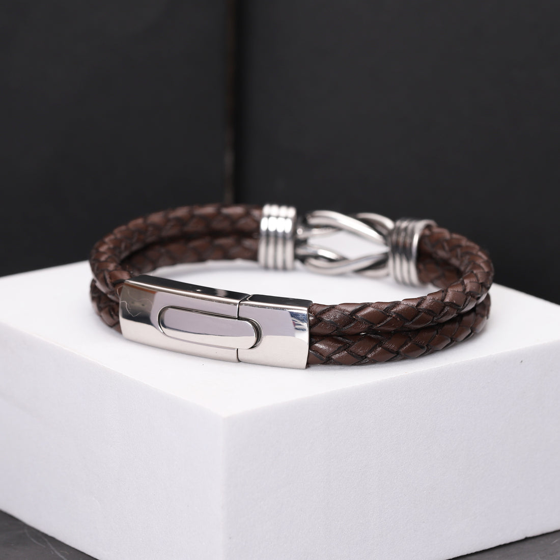 details of leather bracelet with a silver infinity charm, featuring a special message engraved inside the clasp as a personal touch