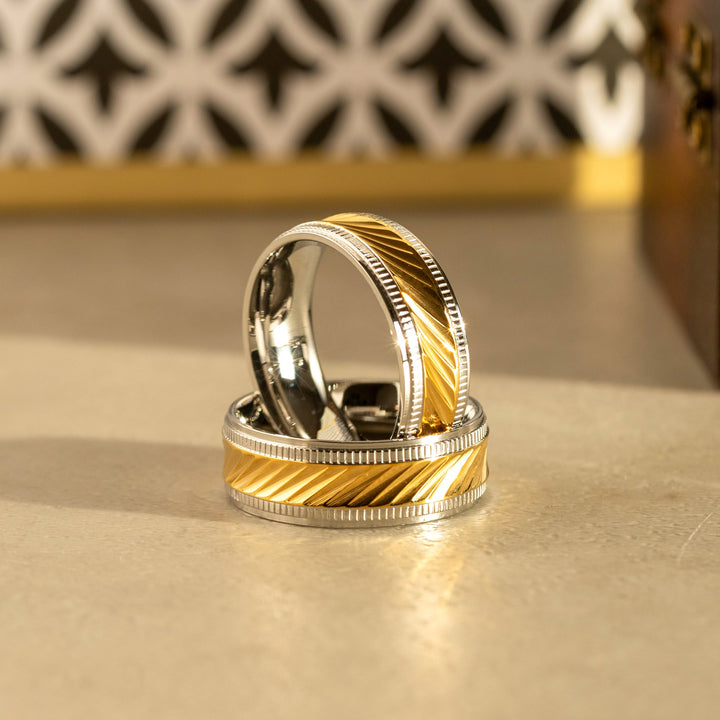 Close-up of a twisted gold band ring for men with a sleek, polished finish, perfect for a wedding or anniversary gift.