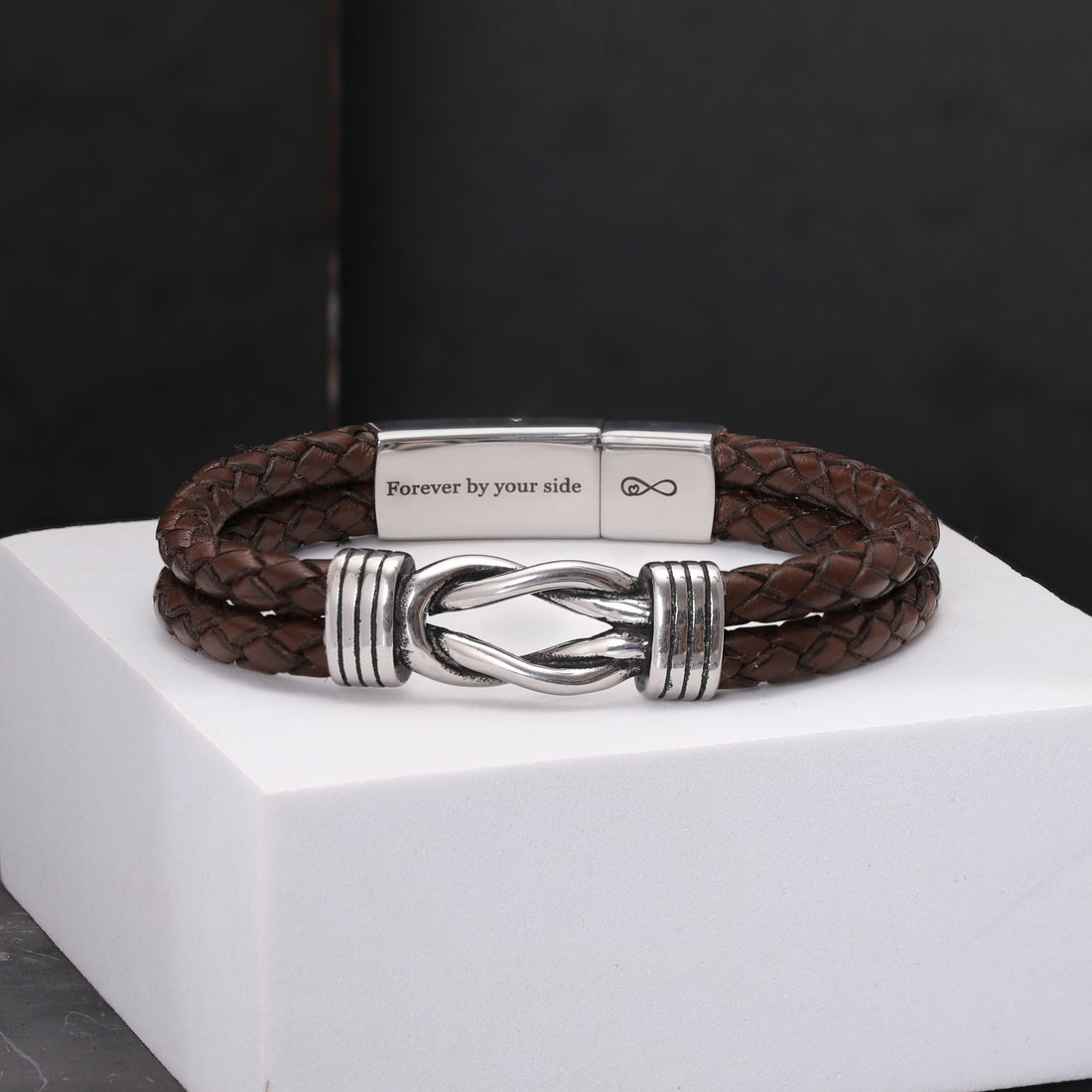 ustomizable leather bracelet with an elegant infinity charm, highlighting the unique inscription hidden within the clasp for an intimate gift