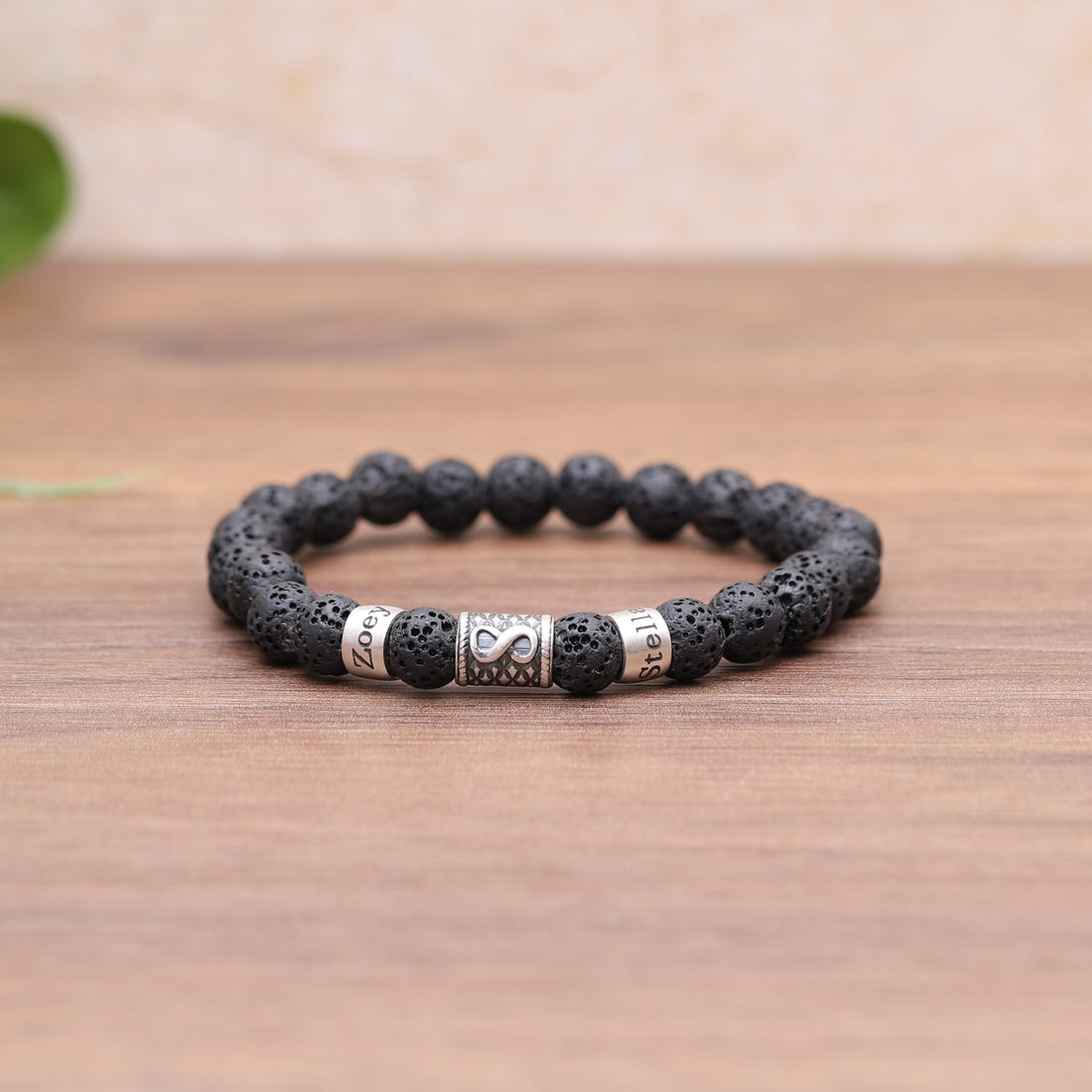 Infinity-themed men's lava bead bracelet with a customizable name plate, symbolizing enduring love and affection, ideal for Valentine's Day.