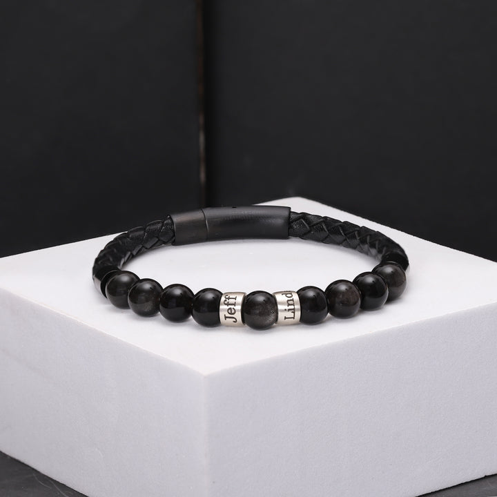 Sophisticated leather bracelet adorned with protective black obsidian beads and personalized silver charms