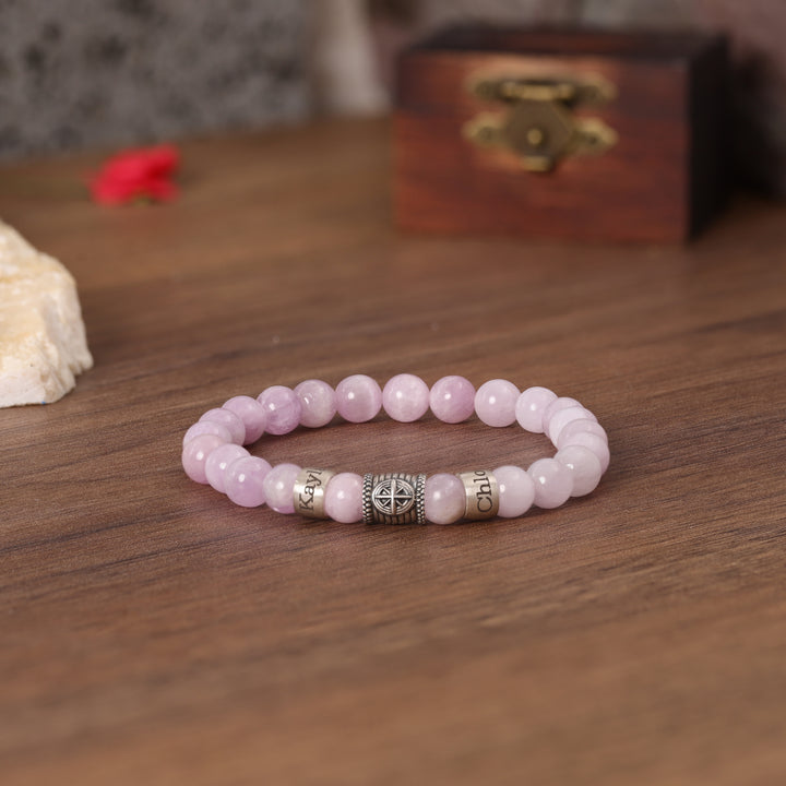 Personalized pink quartz bracelet with a Compass charm, symbolizing finding your way