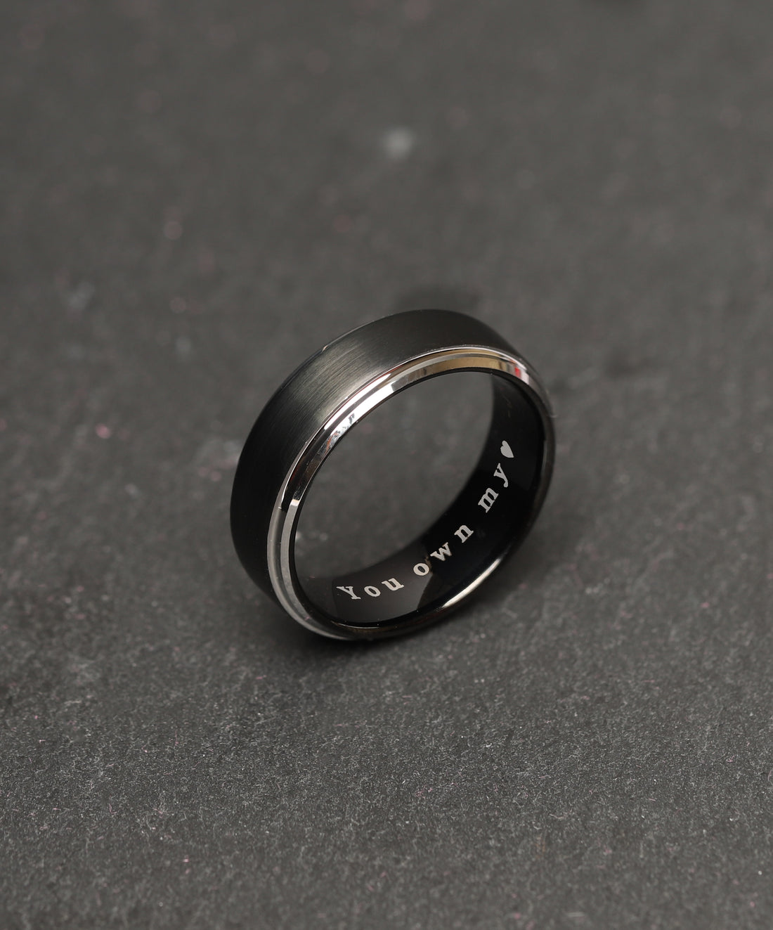 Contemporary men's tungsten ring in a striking black and silver combination, with a sleek profile