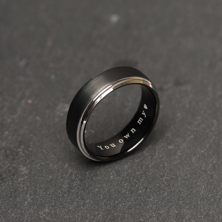 Contemporary men's tungsten ring in a striking black and silver combination, with a sleek profile