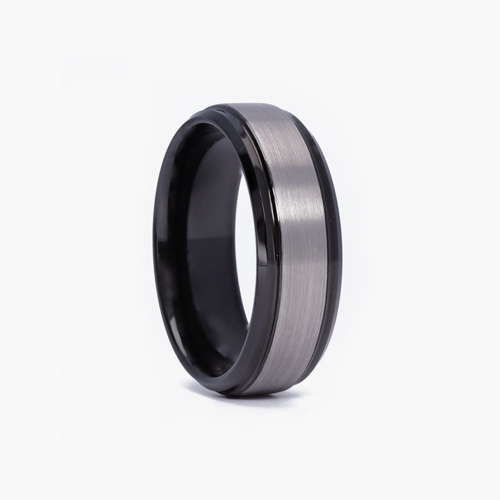 Unique men's promise ring in brushed black tungsten, custom-engraved with a special name or phrase, reflecting a modern and bold style