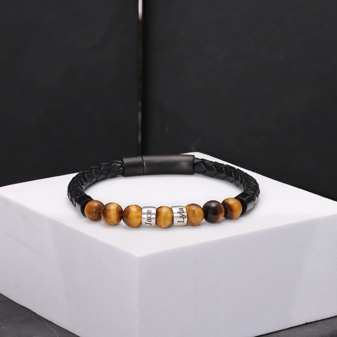 Sophisticated men's bracelet with tiger eye beads, leather strap, and custom sterling silver charms