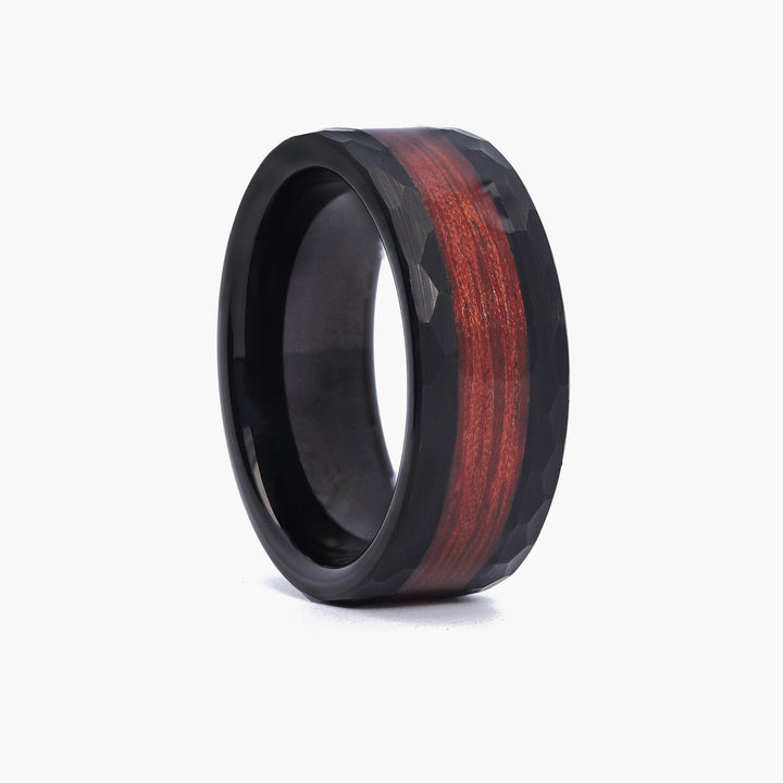 Close-up of a black 8mm hammered tungsten ring for men, showcasing the unique walnut wood inlay